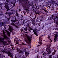 Purple pink lilac orange stone texture. Mountains surface. Close-up. Crushed stone background with space for design. Bright. Beautiful rocky background. 3D shape.