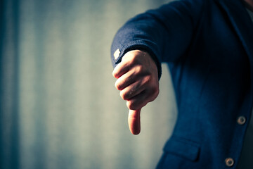 businessman shows thumbs down, the concept of wrong choice