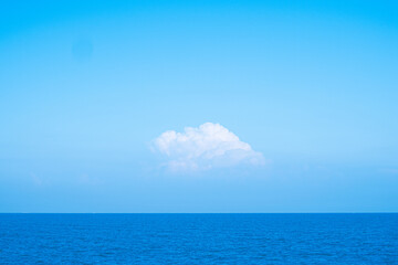 Fototapeta na wymiar Huge white fluffy clouds sky background with blue sky background over ocean