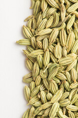 Texture of green fennel seeds on white background. Fennel is a traditional Indian aromatic seasoning and ingredient of Ayurvedic food