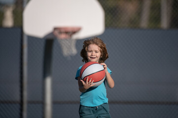Child boy preparing for basketball shooting. Active kids lifestyle.