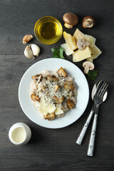 Concept of tasty food with risotto with mushrooms on dark wooden table