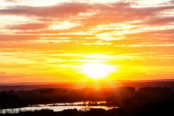 Beautiful sunset on the lake. Sunset background. Sunrise over the lake. Sun rays