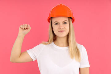 Equality concept with builder woman on pink background