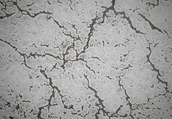 Grunge cracked texture of an old floor. Background of damaged stone