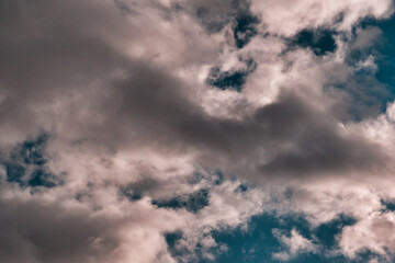 Dark patchy cumulus clouds, deep textured & dramatic with clear patches.