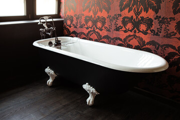 bathroom interior with bathtub and decorative wallpaper