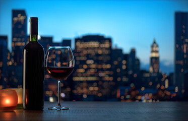 Fototapeta na wymiar Red wine tasting and city skyline in the background