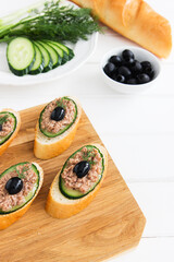 Open tuna sandwiches with cucumber point of view.