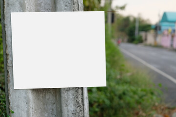 Empty billboard or big board on side of road with green forest and hills on background. Advertising blank, mock up, copy space for your advertisment or promotion text, Concept of advt and trading.
