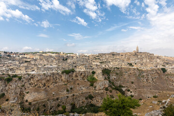 Fototapeta na wymiar Panoramic view of Sassi di Matera a historic district in the city of Matera, well-known for their ancient cave dwellings from the Belvedere di Murgia Timone, Basilicata, Italy