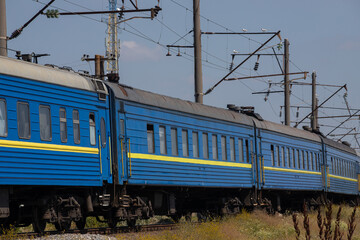 Fototapeta premium Old blue passenger train, carriages on a sunny summer day