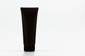 Unbranded plastic black tube for cosmetics products. Skincare and cosmetology mockup with copy space. Branding identity template for text and design