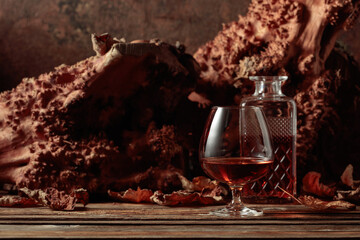 Decanter and glass of brandy on an old wooden table.