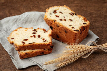 Russian sliced stolichny cake with raisins on brown background