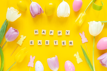 Greeting card with text HAPPY EASTER. Multicolored easter eggs and tulips on yellow background