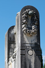 Close-up of an old art nouveau tombstone on blue sky background from cemetery on Brac island in Croatia
