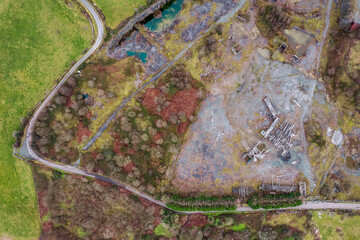 Aerial top down view on an old abandoned open quarry and yard. Stone for construction industry. Nature scene. County Galway, Ireland. Industrial impact on ecology and environment.