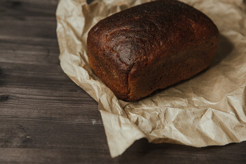 freshly baked black rye bread on a dark background
