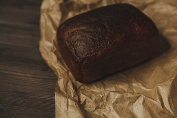 freshly baked black rye bread on a dark background