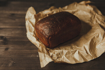 freshly baked black rye bread on a dark background