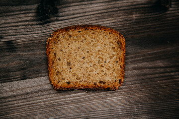 freshly baked black rye bread on a dark background.