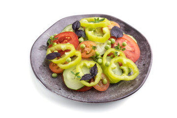 Vegetarian salad from green pea, tomatoes, pepper and basil isolated on white background. Side view.