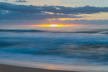 Soft sunrise seascape with clouds