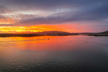 Sunrise waterscape with a mix of low, medium and high clouds