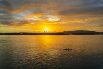 Sunrise waterscape with a mix of low, medium and high clouds