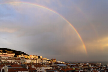 Rainbow over the city of lisbon at sunset from the viewpoint of the elevator of Santa Justa. Portugal.
