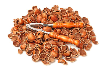 Nutcracker on a pile of empty nutshells isolated on white background