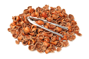 Nutcracker on a pile of empty nutshells isolated on white background