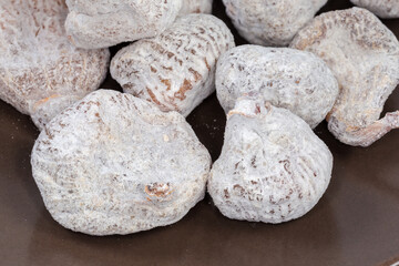 Dried figs on the brown plate, fragment close-up
