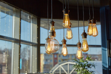 Decorative ceiling light bulbs shine with a dim light. Home decoration and interior elements