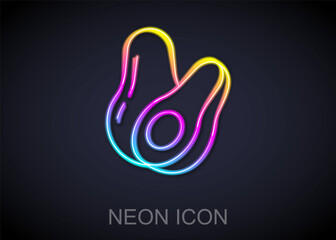 Glowing neon line Avocado fruit icon isolated on black background. Vector