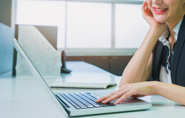 Fototapeta premium women worker typeing computer in office workplace with copy space, professional business worker busy working in office