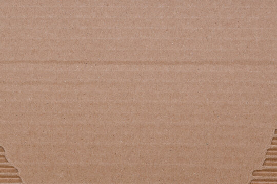 torn brown packing cardboard. background for design