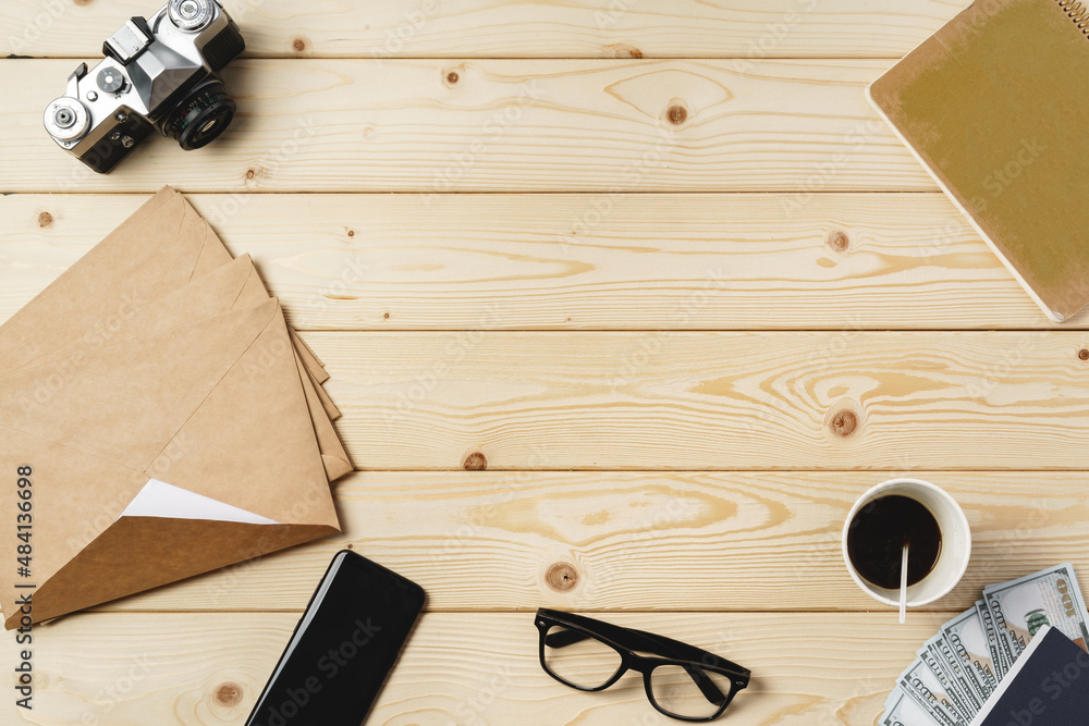 Sticker Working place with envelopes, camera, glasses and smartphone on wooden table top view