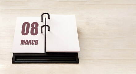 march 8. 8th day of month, calendar date. Stand for desktop calendar on beige wooden background. Concept of day of year, time planner, spring month