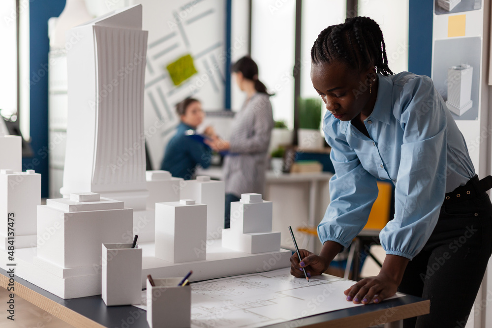 Aufkleber residential architect drawing blueprints at desk in architectural office next to white foam scale mo