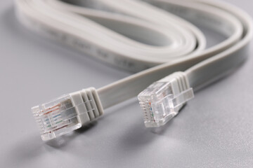 Closeup of rj45 cable on gray background - obrazy, fototapety, plakaty