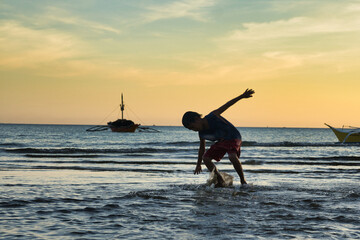 Water play fun at sunset. Bulalacao fishing village, Oriental Mindoro, the philippines
