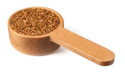 Roasted cumin seeds in the wooden spoon, isolated on the white background.