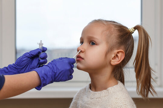 Covid Test In Children. Antigen Quick Test Of Coronavirus In Little Girl Child. Rapid Diagnostic Test  For Kids.