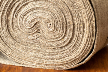 Linen fabric rolled up. Texture of old handmade linen fabric. 