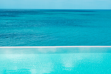 infinity pool at luxury hotel against ocean front, tropical resort. Relaxing, summer,  travel,...