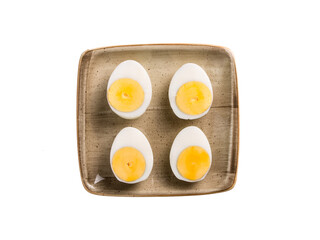 Sliced boiled egg in plate on the white background.top view.
