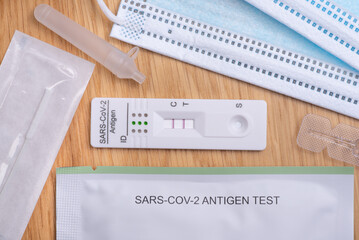 Coronavirus Covid-19 home testing kit with swab and test tube on wooden background with copy space,...