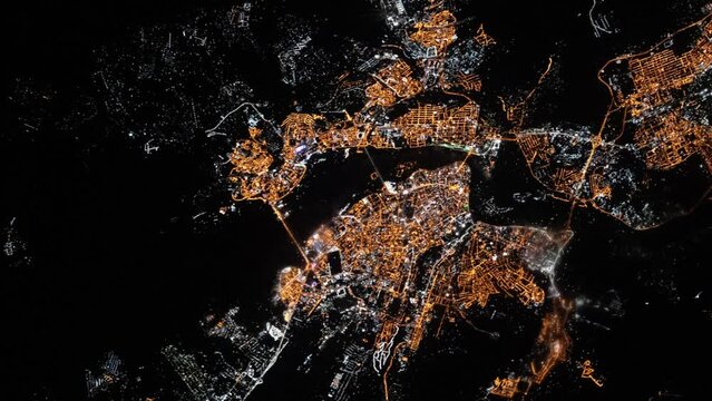 Flying over city of Irkutsk, Russia, night lights aerial satellite view from space animation based on image by Nasa